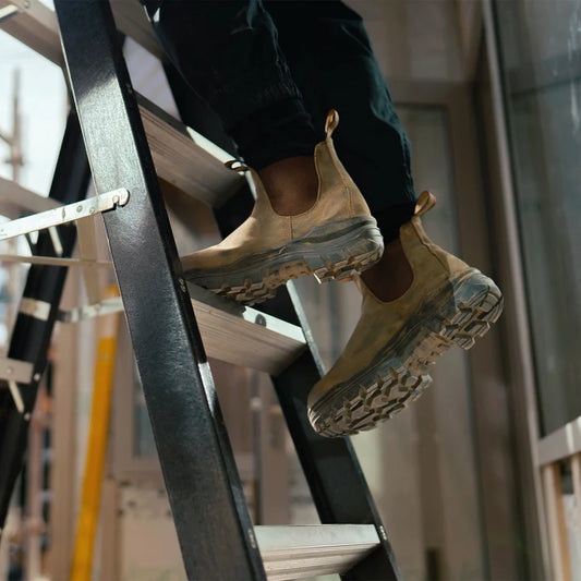New rustic brown rotoflex Blundstone CSA composite toe work boots being worn on a ladder.