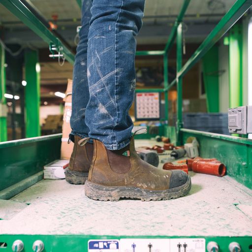 Pair of 169 saddle brown CSA Blundstone boots in saddle brown worn on a worksite.