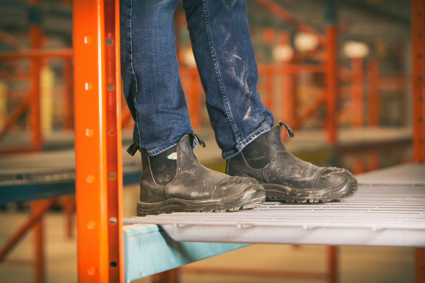 Pair of 168 CSA steel toed Blundstone boots worn on a person on scaffolding.